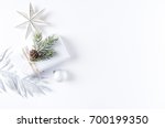 An Arrangement of Christmas Decorations and a Gift Box. Flatlay. Symbolic image. Christmas background. White background. Copy space. Top view.