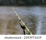 Small photo of fishing line and line snippets on the background of the fading water, fishing season