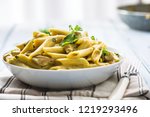 Small photo of Pasta pene with chicken pieces mushrooms parmesan cheese sauce and herb decoration. Pene con pollo - Italian or medierranean cuisine.
