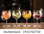 Small photo of Gin tonic long drink as a classic cocktail in various forms with garnish in individual glasses such as orange, grapefruit, cucumber or berries.