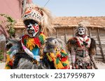 Small photo of Saint Louis, Senegal, Africa, June 12 2023, fake lions in disguise scaring children on a street in the city of Saint Louis