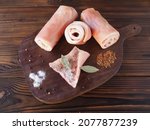 Raw pork skin with spices on a kitchen board on a dark wooden table, flat layout. Natural product for the preparation of national traditional delicacies