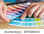 Graphic designer choosing a color from the sampler