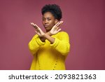 Small photo of Serious young african american woman show stop finish gesture by crossed hands, protest against racial discrimination