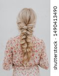 Small photo of Blonde girl with long pull through braid wearing floral pink dress