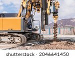 Powerful hydraulic drilling rig on a construction site. Installation of bored piles by drilling. Pile foundations. Drilling in the ground