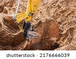 Small photo of Excavator digs piles. Earthworks for the construction of the foundation. Construction equipment for the device of piles. Preparatory work for grillage