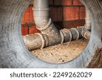 Small photo of Sewer pipes in home basement. System of gray sanitary pipes when building a house. Sewer installation for sewage disposal