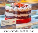 Small photo of Calgary, Alberta, Canada. Feb 8, 2024. A Valentines Red Velvet Cake. Red velvet cake filled with strawberry soft cream topped with Bernie’s and a Re Mine chocolate, that contains: Egg, Milk Soy, Wheat