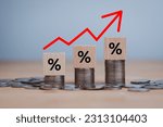 inflation concept, red graph arrow, Percentage sign on a wooden cube with rows of coins in idea for FED considers interest rate hike, world economics, and inflation control, US dollar inflation.