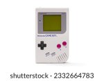 Small photo of Duluth, GA United States 07.15.2023 Retro Nostalgia Capture: Authentic 1989 Nintendo Game Boy, Monochrome Grey Shell with Contrastive Green Screen, Impeccably Preserved, Detailed View white background
