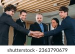 Small photo of Executives in Formal Attire Mark a Momentous Business Partnership with a Handshake. Professional Colleagues Seal a Lucrative Business Deal with a Handshake and Contract Signing.