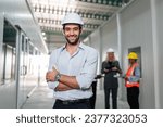 Small photo of Portrait of engineers workers planning and talking in empty warehouse to design the arrangement of product shelves. Team foreman talk details work.