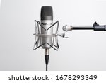  studio microphone for recording podcasts, songs, and radio programs on a white background with a place for inscription. copyspace