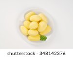 Plate Of Peeled Potatoes On...