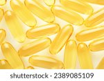 Capsules. Yellow pills isolated on white. Close up capsules with Vitamin D, E or Omega 3,6,9 fatty acids. Food supplement oil filled fish oil. Natural supplements for healthy good life concept. Banner