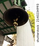 Small photo of KOLKATA, WEST BENGAL, INDIA on 15th. March 2022 at 15:37 pm from a templet. A bell hung with an iron chain in front of a temple.