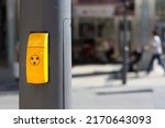 Yellow pedestrian traffic light button. Crosswalk button for traffic light