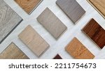 Small photo of samples of interior wooden flooring material consists oak, walnut, ash, douglasfir engineering (or laminate) flooring, ash and oak vinyl tile. top view of selected material board for selection.