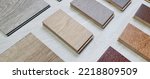 Small photo of samples of interior wooden flooring material consists oak, walnut, ash, douglasfir engineering (or laminate) flooring, ash and oak vinyl tile. perspective view of selected materials on board.