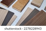 Small photo of variety of wood texture for furniture and flooring furnishing material samples. interior material design samples in close up view. laminated, veneer, engineering wood flooring samples.