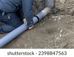 Small photo of A person who performs plumbing work to connect residential drainage to the sewer system
