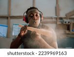 Young African carpenter wood working in factory
