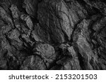   Black white rock texture. Rough mountain surface. Close-up. Dark volumetric stone background with space for design. Crumbled. Weathered.                             