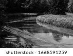 Small photo of Black on Black View of Backward Flow on River in Canada