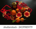 Lunar New year flat-lay with oranges, pot and Chinese wish characters 