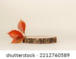 Wooden podium with autumn red leaves, minimal aesthetic background for product presentation