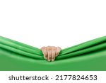 Human hand opening green curtain with white background
