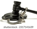 Small photo of Judge gavel and soundboard with handcuff on white background. Law and justice concept