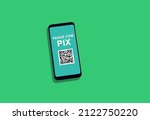 Small photo of Smartphone displaying QR Code for payment via PIX, with green background.