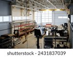 Wide interior shot of metalwork factory equipped with modern industrial machines, copy space