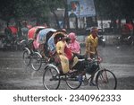 Small photo of Dhaka, Bangladesh - August 08, 2023: Vehicles try to drive through the street during unseasonable rainy day at Dhaka University in Dhaka, Bangladesh.