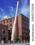 Small photo of Kentucky, USA 07-03-21 The largest baseball bat in the world is located outside the entrance of the Louisville Slugger Museum and Factory, located at 800 West Main Street in downtown