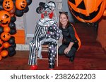 Small photo of Louisville KY USA October 26, 2019 Beautiful lady poses next to a devilish clown as part of the Halloween festivities