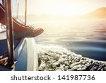 feet on boat sailing at sunrise lifestyle