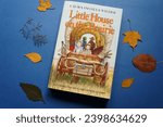 Small photo of Lviv, Ukraine - November 1, 2023: "Little House on the Prairie" book by Laura Ingalls Wilder. Cozy autumn reading concept