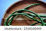 Small photo of Close up isolated flat lay long bean vegetables or Vigna unguiculata ssp sesquipedalian on a wooden tray. Selective focus