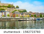 Meuse river with passenger boats and Citadel of Namur fortress on the hill, Namur, Wallonia, Belgium