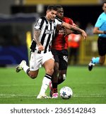 Small photo of MILAN, ITALY - SEPTEMBER 19, 2023: Bruno Guimaraes of Newcastle United and Yunus Musah of AC Milan in action during the UEFA Champions League AC MILAN v NEWCASTLE United FC at San Siro Stadium.