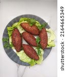 Small photo of kebbe kebe libanais, Kibbeh is a family of dishes based on spiced ground meat, onions, and grain, popular in Middle Eastern cuisine.