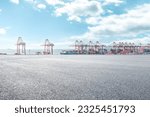 Empty asphalt road and container port background
