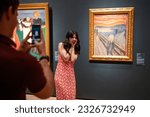 Small photo of Oslo, Norway, June 20, 2023: Tourists observe the famous Edvard Munch composition The Scream at the National Gallery. Visitors take photos mimicing the famous pose.