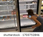 Small photo of Tampa, FL - 4/1/2020: Grocery store shelves are empty in a Florida Publix supermarket. Global supply chains struggle to keep stable food supply amid bottlenecks, customer and employee infections.