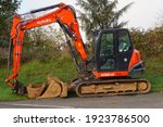 Small photo of Tarn, France - Dec. 2020 - Detail of the rear of a compact mini excavator from the Japanese manufacturer of constrcution equipment Kubota, equipped with a mechanical arm actuated by hydraulic hoses