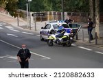 Small photo of Albi, France - Sept. 2021 - Police officers, on foot, by car and by motorbike at a roadblock, control the traffic on the street during a demonstration against the health pass and Covid measures