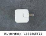 Small photo of Taipei,Taiwan-Jan 11 2021:Apple adapter for iPhone,10W USB power adapter on grey background